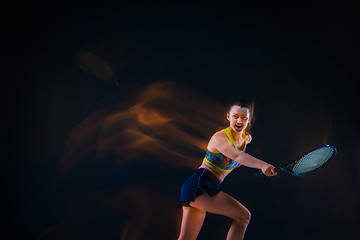 Image showing Portrait of beautiful girl tennis player with a racket on dark background