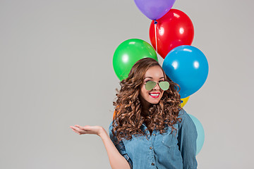 Image showing girl with sunglasses and bunch of colorful balloons