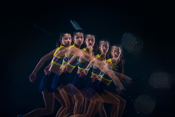 Image showing Portrait of beautiful girl tennis player with a racket on dark background