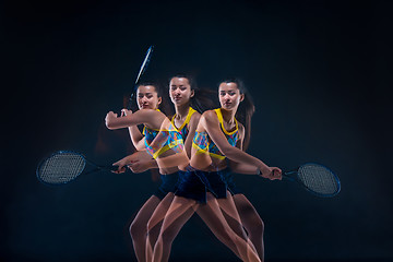 Image showing Portrait of beautiful girl tennis player with a racket on dark background