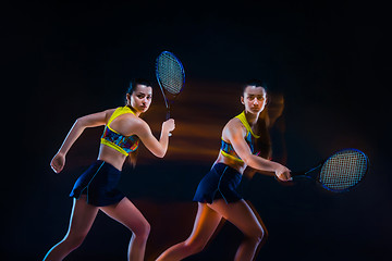 Image showing Portrait of beautiful girl tennis player with a racket on dark background