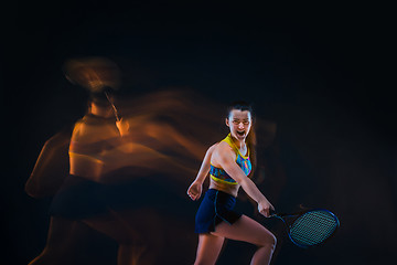 Image showing Portrait of beautiful girl tennis player with a racket on dark background