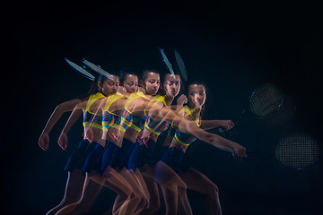 Image showing Portrait of beautiful girl tennis player with a racket on dark background