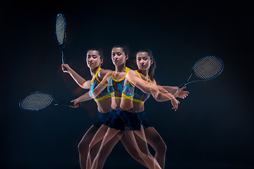 Image showing Portrait of beautiful girl tennis player with a racket on dark background