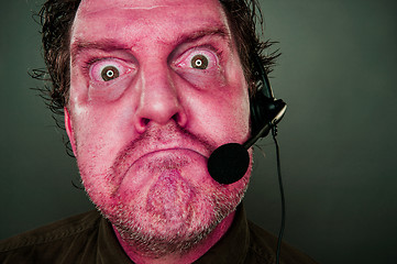 Image showing Grumpy Red Eyes and Face Customer Support Man with Headset