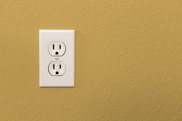 Image showing Electrical Sockets In Colorful Mustard Yellow Wall