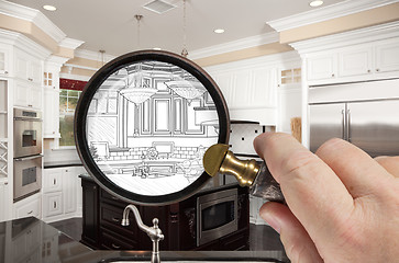 Image showing Hand Holding Magnifying Glass Revealing Custom Kitchen Design Dr