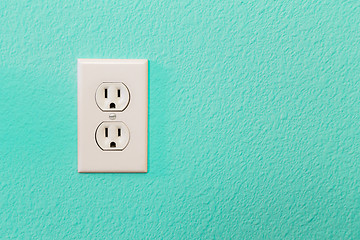 Image showing Electrical Sockets In Colorful Bright Teal Wall