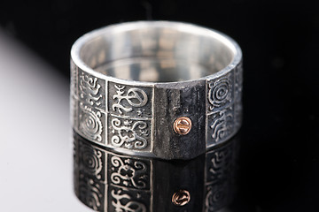 Image showing Handmade jewelry on a black glass