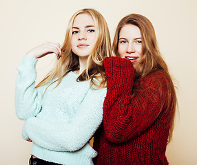 Image showing Two young girlfriends in winter sweaters indoors having fun. Lif