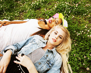 Image showing two pretty school girls on grass happy smiling, best friends hav