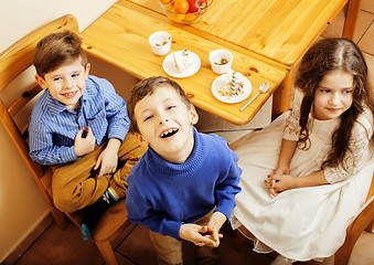 Image showing little cute boys eating dessert on wooden kitchen. home interior. smiling adorable friendship together forever friends, lifestyle people concept