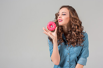 Image showing The smiling girl on gray studio background with round cake