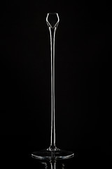 Image showing Tall glass candlesticks against black background