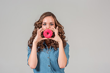 Image showing The smiling girl on gray studio background with round cake