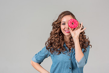 Image showing The smiling girl on gray studio background with round cake