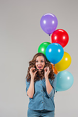 Image showing girl with sunglasses and bunch of colorful balloons
