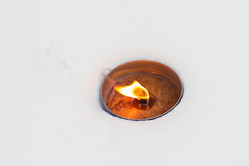 Image showing christmas outdoor candle burning on snow in winter
