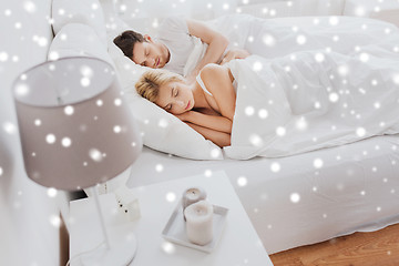 Image showing happy couple sleeping in bed at home