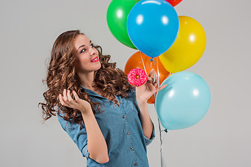 Image showing girl with bunch of colorful balloons