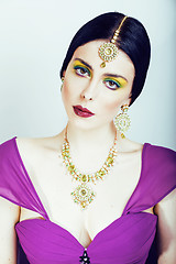 Image showing young pretty caucasian woman like indian in ethnic jewelry close up on white, bridal makeup