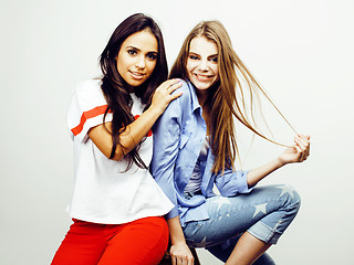 Image showing best friends teenage girls together having fun, posing emotional on white background, besties happy smiling, lifestyle people concept, blond and brunette multi nations