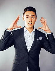 Image showing young pretty business man standing on white background, modern hairstyle, posing emotional, lifestyle people concept