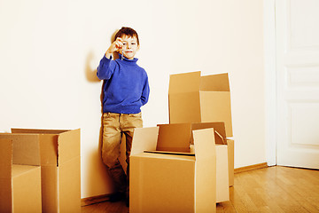 Image showing little cute boy in empty room, remoove to new house. home alone, lifestyle people concept