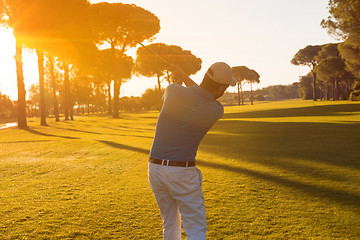 Image showing golf player hitting shot with club