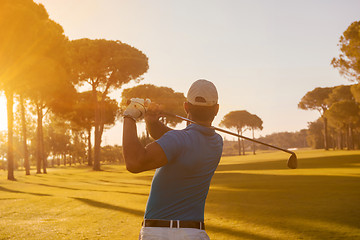 Image showing golf player hitting shot with club