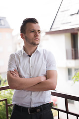 Image showing man standing at balcony