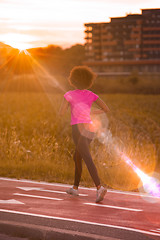 Image showing a young African American woman jogging outdoors