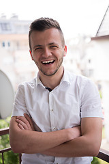 Image showing man standing at balcony