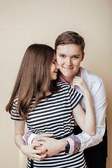 Image showing couple of happy smiling teenagers students, warm colors having a kiss, lifestyle people concept