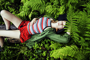 Image showing Pretty young blond girl hipster in hat among fern, vacation in g