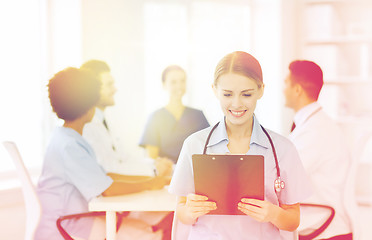 Image showing happy doctor over group of medics at hospital