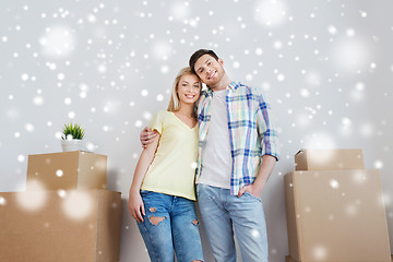 Image showing smiling couple with big boxes moving to new home