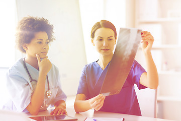 Image showing female doctors with x-ray image at hospital