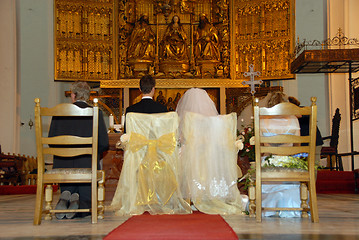 Image showing Young couple at the altar