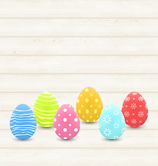 Image showing wooden background with colorful traditional eggs for Easter