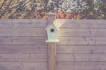 Image showing Cute birdhouse on a wooden fence