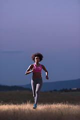 Image showing Young African american woman jogging in nature