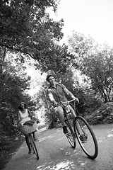 Image showing Young multiethnic couple having a bike ride in nature