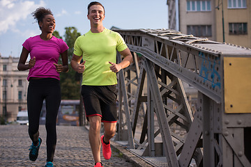 Image showing multiethnic couple jogging in the city