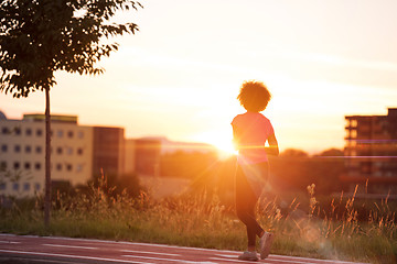 Image showing a young African American woman jogging outdoors