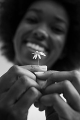 Image showing portrait of African American girl with a flower in her hand