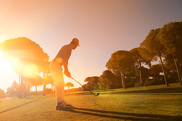 Image showing golf player hitting shot with club