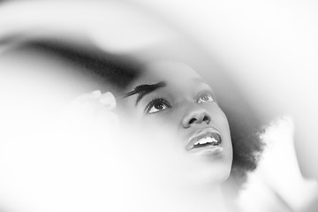 Image showing young African-American woman makeup in the car