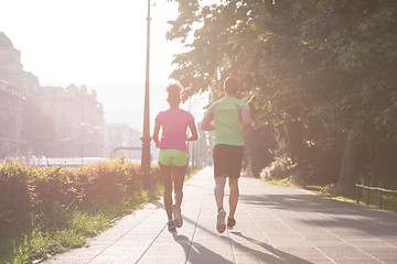 Image showing young multiethnic couple jogging in the city