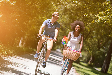 Image showing Young multiethnic couple having a bike ride in nature